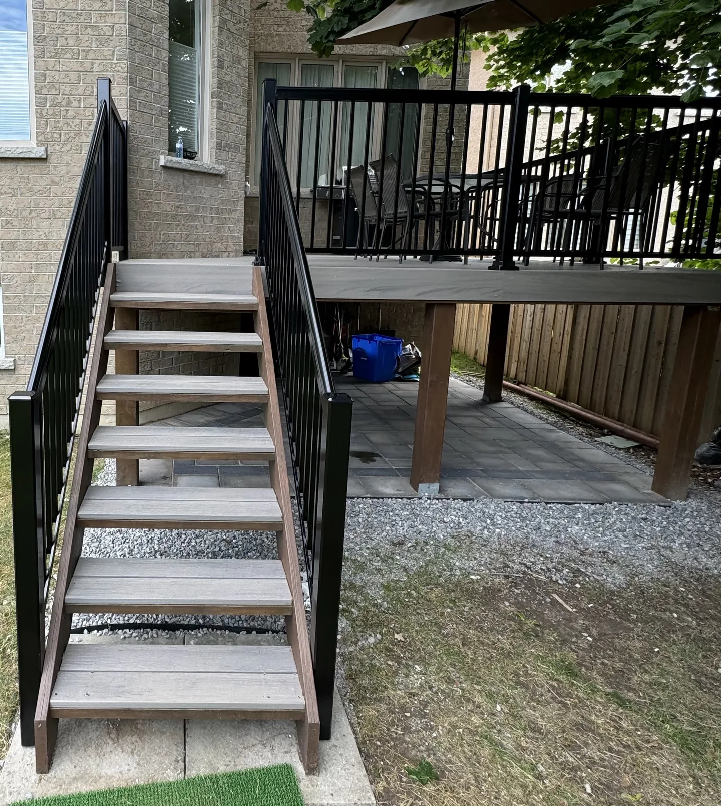 Grey composite deck stairs with black exterior railings