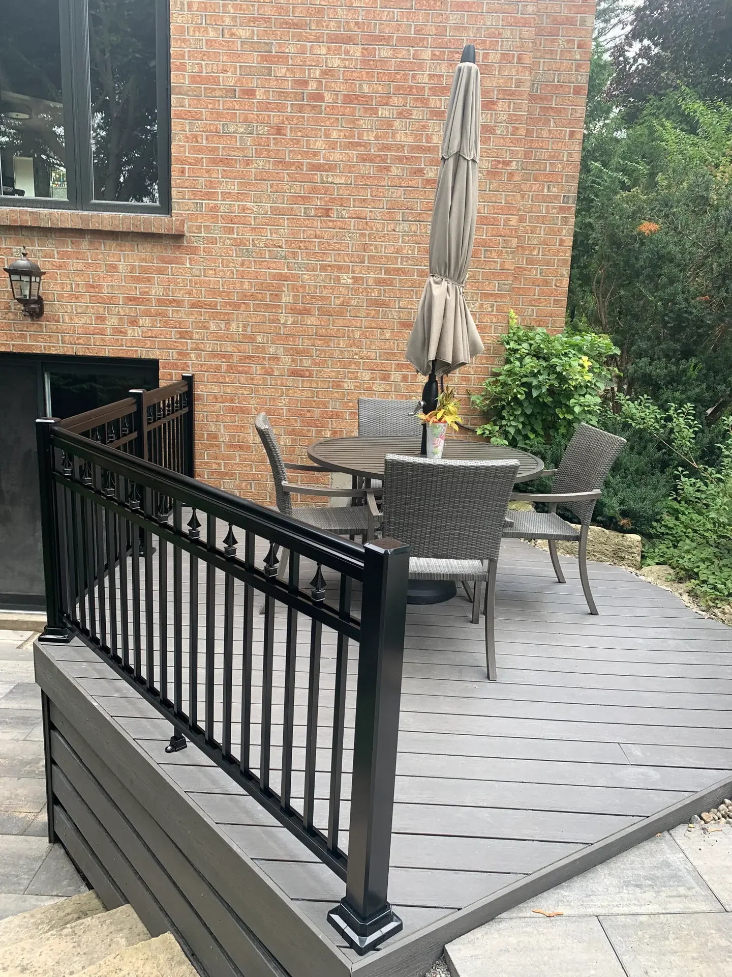 Grey backyard deck with black exterior railing