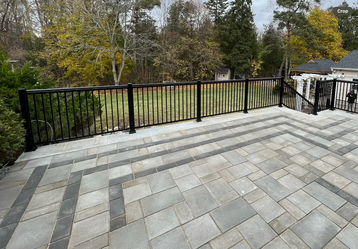 Black metal railing bordering an outdoor paved area